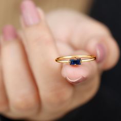 Product Details Celebrate your love and commitment with this beautiful Promise Ring. Adorned with a Baguette Cut Blue Sapphire set in a Four Prong Diagonal Setting, this ring is crafted in solid gold for a timeless and elegant look. The simple yet striking design of this Blue Sapphire Solitaire Ring makes it a perfect symbol of your promise to each other. Product Information SKU SHP-RINGS032218608 Width 1.5 mm Height 3.2 mm Weight 1.28 gm (Approximate) BLUE SAPPHIRE INFORMATION No.of Stones 1 Pi Gold Sapphire Ring Simple, Sapphire Ring Simple, Beautiful Promise Rings, Sapphire Solitaire Ring, Gold Sapphire Ring, Sapphire Solitaire, 18k Yellow Gold Ring, Signature Jewelry, Blue Sapphire Rings