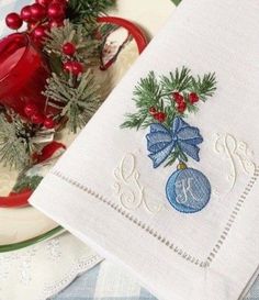 a white plate topped with a christmas ornament next to a cup and saucer