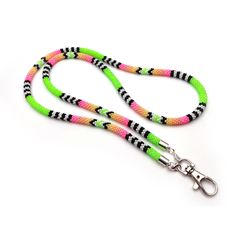 a dog leash with neon green, pink and black stripes on the end of it