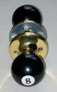 a black and gold door knob with a number eight on it