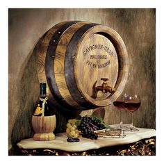 two wooden barrels with wine glasses on a table next to grapes and cheese, along with a bottle of wine