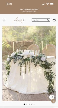 the wedding table is decorated with greenery and candles