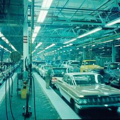 an assembly line with many cars on the assembly line