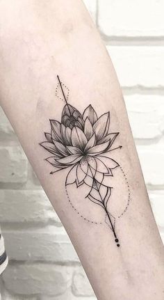 a lotus flower tattoo on the arm