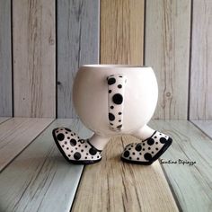 a ceramic cup with black and white polka dots on it