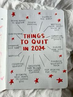 an open notebook with things to quit in 2014 written on the pages and red stars