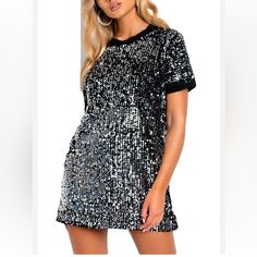 A Perfect Party Dress Mochy Sequin T-Shirt Mini Dress In Silver Black Detail Trim Around Sleeves And Neck Area Size-S/M (Measurements On Photos) New With Tags Fitted Silver T-shirt With Short Sleeves, Glamorous Short Sleeve T-shirt For Night Out, Party Sequin Short Sleeve T-shirt, Black Sequin Short Sleeve T-shirt, Silver Sequined Short Sleeve Tops, Black Short Sleeve Sequin Party Dress, Silver Crew Neck Top For Party, Black Sequined T-shirt For Party, Silver Short Sleeve T-shirt For Summer