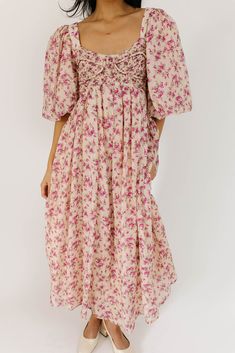 whether you’re searching for the perfect wedding guest dress, or for an excuse to feel like a princess, this puff sleeve midi dress does not disappoint. it features a stunning pink vintage floral pattern, dramatic puff sleeves, + a flirty corset-inspired bodice. the perfect long formal dress for garden parties, fancy dinners, + anytime you feel like frolicking. pink + purple floral // midi length, scoop neckline, dramatic puff sleeves, back zipper closure, smocked bodice, fully lined model is 5'8" + wearing a small measurements are approximate + taken while laying flat small : bust 31” (smocked) length 48” medium : bust 33” (smocked) length 49” large : bust 36" (smocked) length 49" xlarge : bust 38" (smocked) length 49" more fit + fabric info : polyester, cotton // fabric has no stretch (b Feminine Floral Print Midi Dress With Puff Sleeves, Floral Print Midi Puff Sleeve Dress For Garden Party, Floral Print Puff Sleeve Midi Dress, Garden Party Floral Print Midi Puff Sleeve Dress, Puff Sleeve Floral Dress For Brunch, Brunch Floral Print Midi Dress With Puff Sleeves, Puff Sleeve Midi Dress With Floral Print For Brunch, Spring Midi Dress With Floral Print And Puff Sleeves, Pink Floral Print Maxi Dress With Puff Sleeves