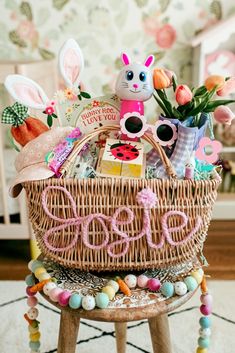 a basket filled with toys sitting on top of a wooden stool