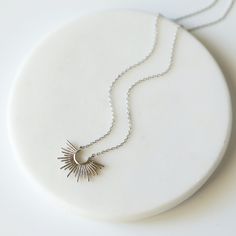 "Beautiful and lovely sunburst pendant necklace. Made of silver color sunburst pendant with skinny rhoidum plated brass chain. Soft and simple. Great for gift , everyday or special occasion. Your item will ship in a gift box. Please feel free to contact me if you have any question. ♥ Length 14\" - 18\" ♥ Pendant 1/2\" ♥ Rhodium plated over brass ♥ Creation Time: 1 - 3 days ♥ See more Rudiana Accessories Rudiana.etsy.com" Silver Sun Design Necklace For Gift, Silver Necklace With Sun Design As A Gift, Silver Necklace With Sun Design For Gift, Silver Celestial Necklace With Sun Design, Silver Sunburst Necklace For Gift, Starburst Jewelry With Sun Design As A Gift, Silver Sunburst Jewelry For Gifts, Dainty Silver Starburst Jewelry, Starburst Sun Design Jewelry Gift