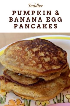 a stack of pancakes sitting on top of a yellow and white plate next to a pink fork