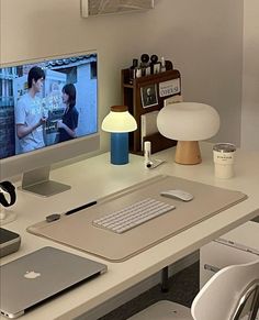 an apple computer sitting on top of a white desk