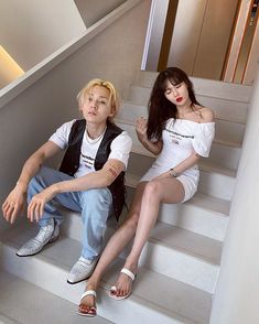 two people are sitting on the stairs together