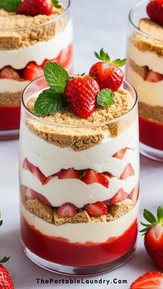 three layered desserts with strawberries on top