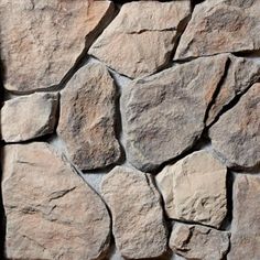 a stone wall that is made out of different types of rocks and has been used as a background