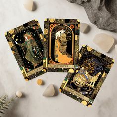 three tarot cards sitting on top of a table