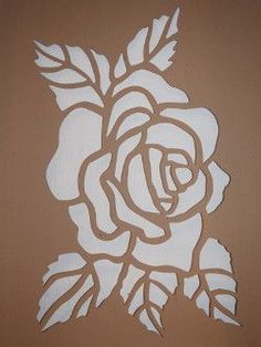 a white rose cut out on a brown background