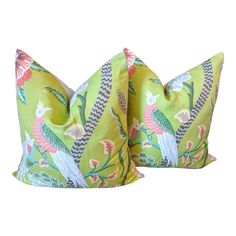 two green pillows with colorful designs on them