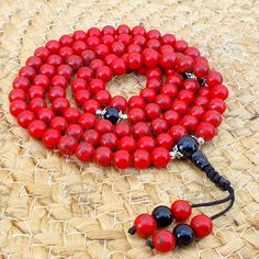 📿This Buddhist Mala is handcrafted with Red Howlite Beads and Black Agete Guru Bead. It encourages emotional expression and strengthens learning abilities. It promotes patience, tolerance, clear communication, and proper expression of unprocessed emotions. They help develop a connection with the higher self. It brings peace, harmony, insight, and spiritual alignment. This Statement Jewelry encourages a better understanding of self and heightens awareness.📿 ✨ MALA DETAILS ✨ 🧧8MM Round Red Howl Traditional Red Bracelets For Meditation, Red Coral Jewelry With 8mm Beads, Red Spiritual Bracelets With 108 Beads, Red Spiritual Bracelet With 108 Beads, Red 8mm Beads Jewelry For Meditation, Red Round Bracelets For Meditation, Adjustable Red Beaded Bracelets For Meditation, Handmade Red Coral Beads, Handmade Red Coral Round Beads