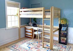 a bedroom with a bunk bed, desk and rug in the corner on the floor