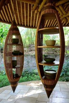 two wooden boats sitting on top of a tiled floor next to a wall filled with plates and bowls