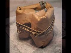 a brown bag sitting on top of a table next to a pair of metal scissors