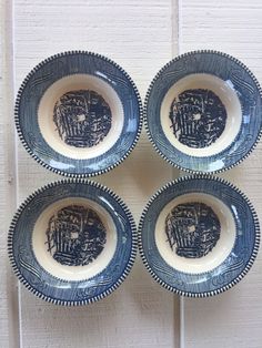 four blue and white plates with designs on them