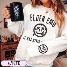 This cozy sweatshirt is the perfect gift for the elder emo in your life. Each sweatshirt has the smile face on the outer lower left sleeve as pictured. This crewneck sweatshirt is pure comfort. Made from a soft cotton/poly blend with no itchy side seams, this is sure to become a staple. SIZE AND FIT: Your sweatshirt design will be printed on a high-quality, soft and comfortable unisex sweatshirt. Sizes run true to size, which takes the guesswork out of ordering; if you like your sweatshirts loos Emo Lyrics, Pop Punk Music, Emo Gifts, Elder Emo, Punk Shirt, Punk Music, The Smile, Pop Punk, Cozy Sweatshirts