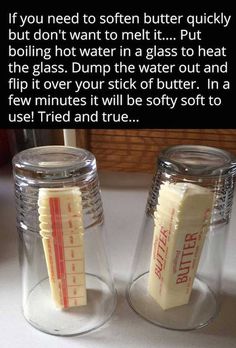 two jars with fake toothbrushes in them sitting on a counter next to each other