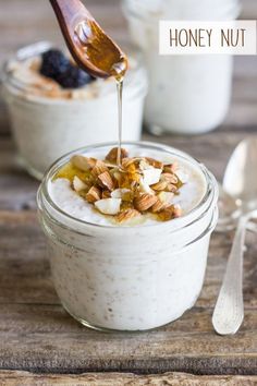 a spoon drizzling honey into a bowl of oatmeal with nuts