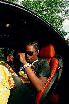 a man sitting in the back seat of a car