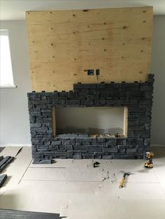 a fireplace being built in the middle of a room