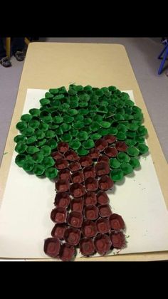 a tree made out of wine bottles sitting on top of a cutting board