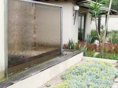 a water fountain in front of a house