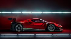 a red sports car parked in a dark room