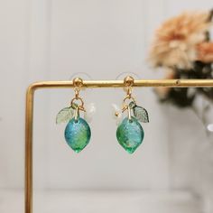 Our cute lime earrings are made with glass lime, acrylic leaf, acrylic flower and 14k gold plated studs/hooks which are good for delicate ears. We have 925 sterling silver plated version available, please contact seller for detail.Size: the stud style(W x L): 0.5" x 1.1" the hook style(W x L): 0.5" x 1.5" Elegant Green Resin Earrings, Dainty Green Summer Jewelry, Green Leaf-shaped Party Jewelry, Elegant Green Resin Jewelry, Green Earrings For Summer Gift, Trendy Leaf-shaped Earrings For Gifts, Cute Green Jewelry For Party, Summer Gold Resin Earrings, Trendy Lime Green Jewelry Gift