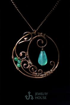 a necklace with a green stone hanging from it's center, on a black background