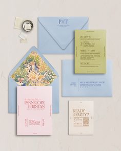 an assortment of wedding stationery and envelopes