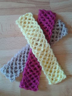 three crocheted ties on top of a wooden table