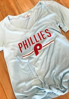 the philadelphia phillies shirt is laying on the floor