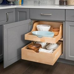 an open drawer in the middle of a kitchen