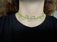 A choker necklace made with silver chain and green seed beads. Creates a wavy effect that adds a fun touch to any outfit! Trendy Green Necklace For Party, Green Beaded Chain Necklace As Gift, Trendy Festival Beaded Chain Choker, Trendy Green Choker For Party, Green Beaded Choker Necklace For Party, Green Beaded Choker For Party, Green Adjustable Chain Necklace For Party, Trendy Green Beaded Chain Necklace, Trendy Green Beaded Necklace