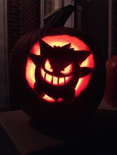 a pumpkin carved to look like a cat