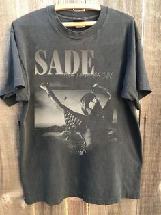 a t - shirt that says sade on the front, and an image of a woman