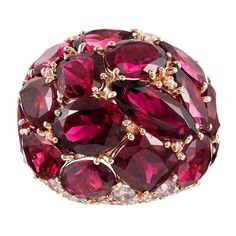 Warm hues of magenta rubellite are peppered with brilliant white diamonds atop a polished mounting of 18 karat rose gold. The ring boasts playfulness and mid-century-inspired character in addition to its 20 carats of tourmaline and .70 carats of diamonds. Generous in both style and substance, this bit of fine fashion jewelry can be enjoyed with both formal and informal attire. Compliment will ensue. Size 6.5 can be resized on request. Luxury Vintage Red Ruby Ring, Formal Luxury Ruby Ring, Luxury Polished Red Ruby Ring, Luxury Red Ruby Diamond Ring, Luxury Ruby Ring Fine Jewelry, Luxury Fine Jewelry Ruby Ring With Diamonds, Luxury Ruby Gemstone Cluster Ring, Luxury Red Sapphire Gemstone Ring, Luxury Red Diamond Ring