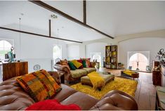 a living room filled with furniture and lots of windows