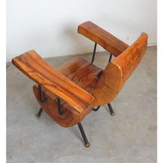 a wooden chair sitting on top of a cement floor