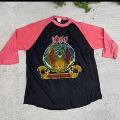 1985 Dio Sacred Heart Tee Vintage 80s Men’s Cotton Metal Band Tour Concert Raglan Dragon Graphic T-Shirt S/Small/M/Medium Vintage Long Sleeve Tops For Concert, Vintage Long Sleeve Concert T-shirt, Vintage Long Sleeve T-shirt For Concerts, Vintage Red Shirt With Graphic Print, Retro Red Shirt With Graphic Print, Vintage Shirt With Graphic Print For Concerts, Retro Red Graphic Print Shirt, Vintage Red Long Sleeve T-shirt, Red Vintage Print Cotton Top