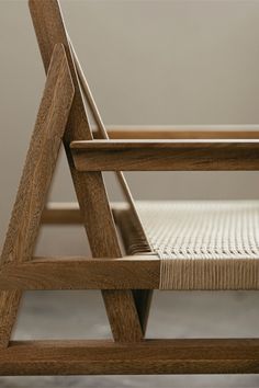 a close up of a wooden chair with woven seat padding and backrests