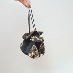 A divine little 1930s evening bag/purse, in black rayon, with drawstring fastening. Gathered into a square-bottomed pouch, it is heavily detailed with twinkling graphite silver faceted sequins and glass seed beads. Fits a surprising amount in! I also have this available with gold sequins in store Main body of the bag is just over 4" cubed Excellent condition, minor fraying to the ends of ties but nothing to note on bag! SHIPPING is untracked insured to £20, select an upgrade at checkout for full Vintage Evening Shoulder Bag With Metal Hardware, Vintage Sequined Rectangular Evening Bag, Vintage Evening Bag With Gold-tone Hardware For Party, Luxury Vintage Evening Bag With Gold-tone Hardware, Vintage Evening Bag With Turn-lock Closure, Evening Purse, Gold Sequins, Silver Sequin, Wrist Strap